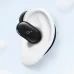 Close-up of a black soundcore V20i open-ear earbud worn on an animated ear.