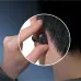 Close-up circle showing the secure clip-on fit of the EarFun Clip 2 earbud on a person's ear.
