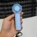 Handheld view of Baseus GoTrip DT1 Mini Handheld Turbine Fan showing compact grip and circular vent head