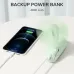 Desk view of the Jisulife Life8 Plus F8X 3-in-1 Foldable Handheld Fan used as a backup power bank charging a smartphone.