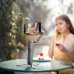 Woman recording video using DJI Osmo Mobile 8P gimbal outdoors, capturing stable footage with smartphone mounted.