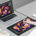 Hand using stylus on drawing tablet beside laptop, creating colorful digital art in a modern workspace setting.