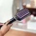 Close-up hand-held view of the Philips BHH880 Hair Straightener brush showing its bristle array.