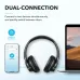 The Anker Soundcore Q20i connected to both a smartphone and laptop, demonstrating its dual-connection capability for seamless switching between devices.