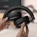 Lifestyle view of the XO BE55 ANC Wireless Bluetooth Headphone being held to display its foldable over ear design