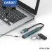 Angled top view of the Onten OTN-5706 4-in-1 USB Hub with 3.5mm Jack connected to a laptop showing ports and compact body.