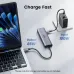 UGREEN CM511 USB-C hub connected to a laptop and a power adapter, illustrating 100W input and 85W output for fast charging.