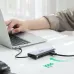 UGREEN CM639 USB-C Hub connected to a laptop on a desk while a person types, emphasizing the 1000 Mbps Ethernet port.