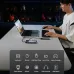 A man uses the UGREEN CM888 hub connected to a laptop. Icons list compatible accessories: keyboard, mouse, flash drive, etc.
