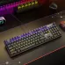 Angled desk view of the Meetion MT‑MK009RD RGB Hot‑Swappable Mechanical Keyboard showing full RGB backlit keys on a gaming setup surface