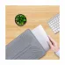 Overhead view of a hand sliding a silver laptop into the gray Bwoo CB43-G bumper sleeve case on a wooden desk.