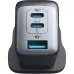 Top-down desk view of Anker PowerPort III 3-Port 65W Pods Charger Adapter (A2667K14) connected to multiple devices via cables