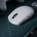 Top view of MCHOSE G3 V2 Pro Mouse in white with side buttons, placed on green cutting mat beside gaming controller.