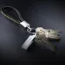 SanDisk Ultra Luxe USB flash drive attached to keychain with metal keys, premium silver design on dark background