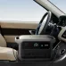 Car interior view of Anker SOLIX C2000 Gen 2 Portable Power Station on passenger seat showing 50% battery.