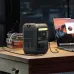 Desk view of Anker SOLIX C300 Portable Power Station powering laptop with multiple ports and light strip visible.