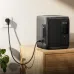 EcoFlow DELTA 3 Air 1000 Portable Power Station placed on a table while plugged into a wall outlet for charging.