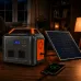 Indoor view of EcoSONIC AP-500 500W Portable Power Station with solar panel charging phone and powering accessories.