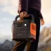 Outdoor handheld view of the Jackery Explorer 2000 v2 2200W Portable Power Station being carried by its handle.