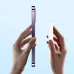 Comparison view of Baseus PPCXM05 5000mAh Magnetic Power Bank held beside slim purple smartphone for size reference.