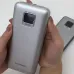 Handheld close-up of Foneng PX151 20000mAh 22.5W Power Bank highlighting compact size and screen interface with charging indicators