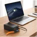 Workspace view with Hoco DB100A Harmony 50000mAh 65W Fast Charging Power Bank charging a MacBook Pro