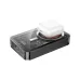 Transparent  Hoco Q14A 10000mAh magnetic wireless power bank in black, shown from an angled top view charging a white earbud case.