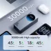 30000mAh power bank with digital display on desk, showing high capacity charging for phone, laptop, tablet, and earbuds setup