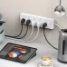 Kitchen view of Huntkey DMC502 Power Strip mounted with five plugs powering kettle and appliances beside tablet.