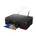 Canon Pixma G570 Color Printer shown in angled rear view printing a colorful photo from the output tray.