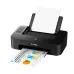 Black Canon PIXMA TS207 printer with paper loaded in the rear tray and a printed page exiting the front slot.