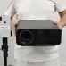 Front holding view of AUN U001 Pro 1000 ANSI Lumens 4K Android Projector showing lens and compact design