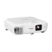 Epson EB-994F projector angled front view with lens, ventilation grille, and adjustable projector feet.