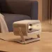 Side perspective of the projector on a desk with lens facing forward in a warm indoor setting