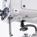 Close-up of the underside of the Jack T1377E button sewing machine head, showing the needle bar, presser foot, and LED light.
