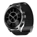 A black smartwatch with a jeweled bezel and black mesh band, displaying a classic black watch face with Roman numerals.