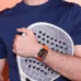 Close-up of a HUAWEI WATCH FIT 5 Pro on a wrist holding a sports racket.