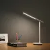 Workspace view of Yeelight Z1 Pro Table Lamp illuminating desk with framed photo, pencils, and closed book.