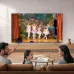 Living room view of Samsung 65U8500H 65 inch Crystal 4K UHD LED Smart TV showing people watching colorful display