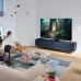Living room view of Samsung 65QN85C TV wall-mounted displaying vivid fantasy portal scene.