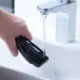 Cleaning view of Panasonic ER-GB37 Trimmer rinsed under faucet showing waterproof design and easy blade maintenance.