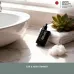 Bathroom counter view of Panasonic ER115KP Nose Trimmer beside towel, plant, and cotton emphasizing Japan quality.