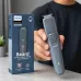Philips 1000 Series beard trimmer held in hand beside its box, showcasing the trimmer design and green power indicator.