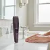 Philips BT3415/15 beard trimmer displayed on a bathroom counter with adjustable length settings and LED indicator.