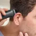 Lifestyle view of Philips MG3747/13 Trimmer used around ear area with comb attachment for precise and even haircut trimming.