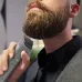 Close-up of Philips MG5930/15 Trimmer in use, trimming beard near chin with green light indicator and ergonomic black handle.