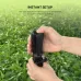 Hands setting up the black Fantech SS141 portable tripod/monopod in a field of green plants.