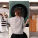 Lifestyle view of LG WT1410NHEG Front Load WashTower with person organizing clothes beside stacked washer and dryer unit.